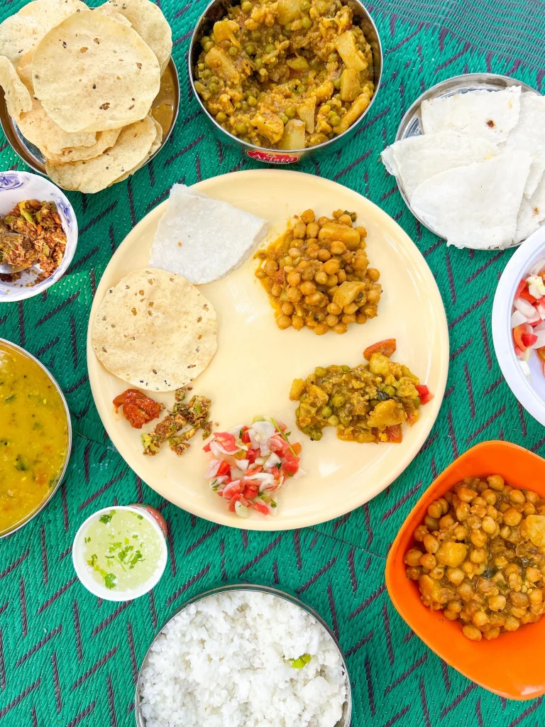 Traditional Indian thali with rice, curry, roti and chutneys