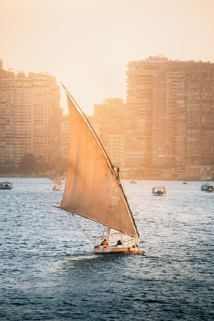 Traditional felucca sailboat on the Nile River at sunset