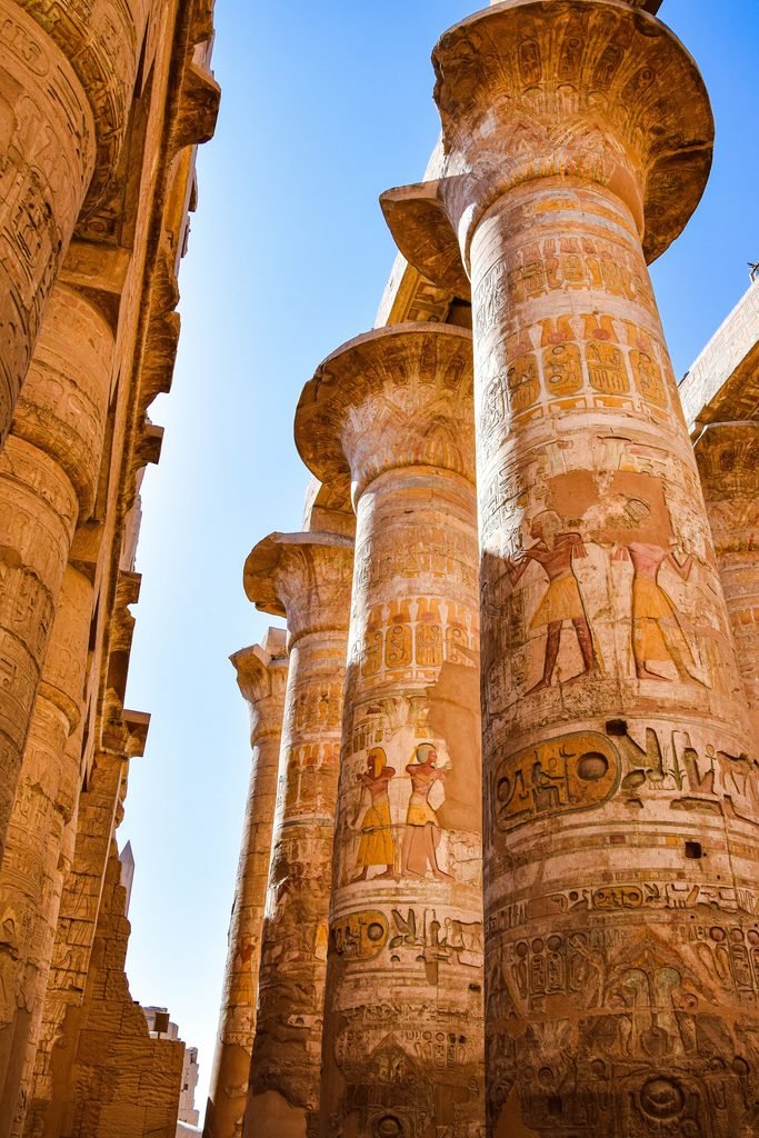 Hieroglyph-covered stone columns at Karnak Temple in Luxor, Egypt
